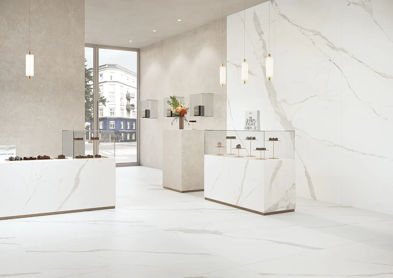 Modern retail showroom featuring large format white marble effect ceramic tiles with grey veining on floors and walls.