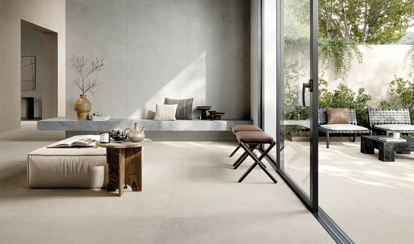Living room with stone effect porcelain tile flooring that connects indoor and outdoor spaces