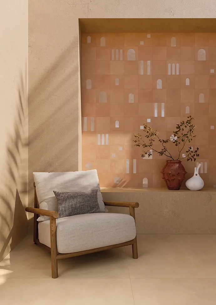 Modern living room featuring warm terracotta effect ceramic tiles and decorative geometric patterned tiles in contemporary interior.
