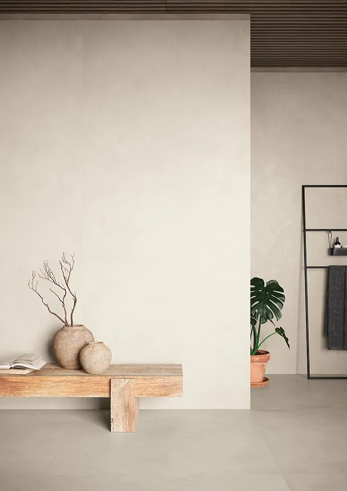 Minimalist entryway floor featuring grey concrete look tiles.