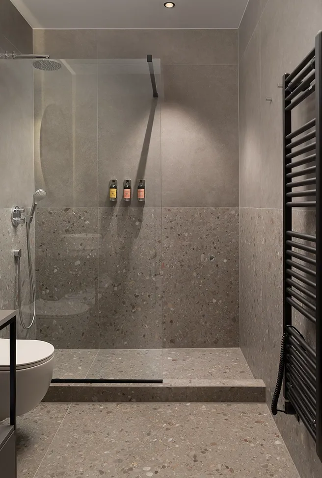 Nicchia doccia con piastrelle in gres porcellanato effetto cemento grigio grande formato su pareti e mensola