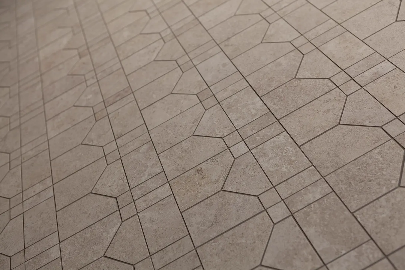 Azulejos de gres porcelánico efecto piedra con incisiones y motivos geométricos decorativos.