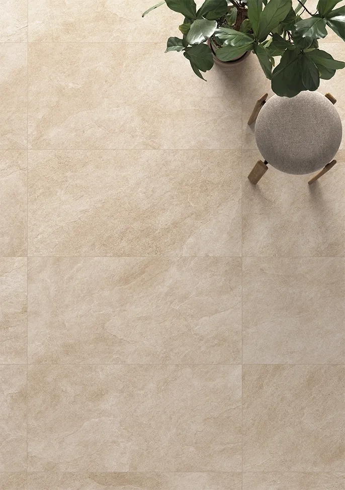 Light beige stone-effect porcelain pavers on a sunlit outdoor patio