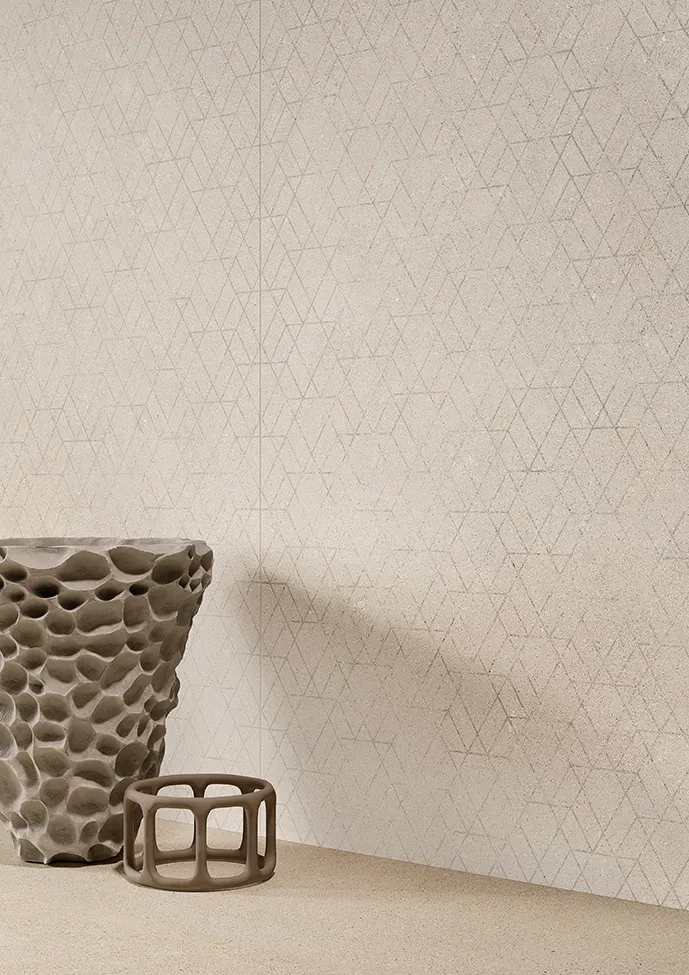 Bathroom wall with handmade-look beige tiles and geometric texture.