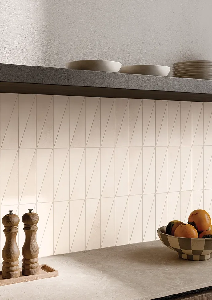 Kitchen backsplash with handmade-look beige tiles and diagonal pattern.