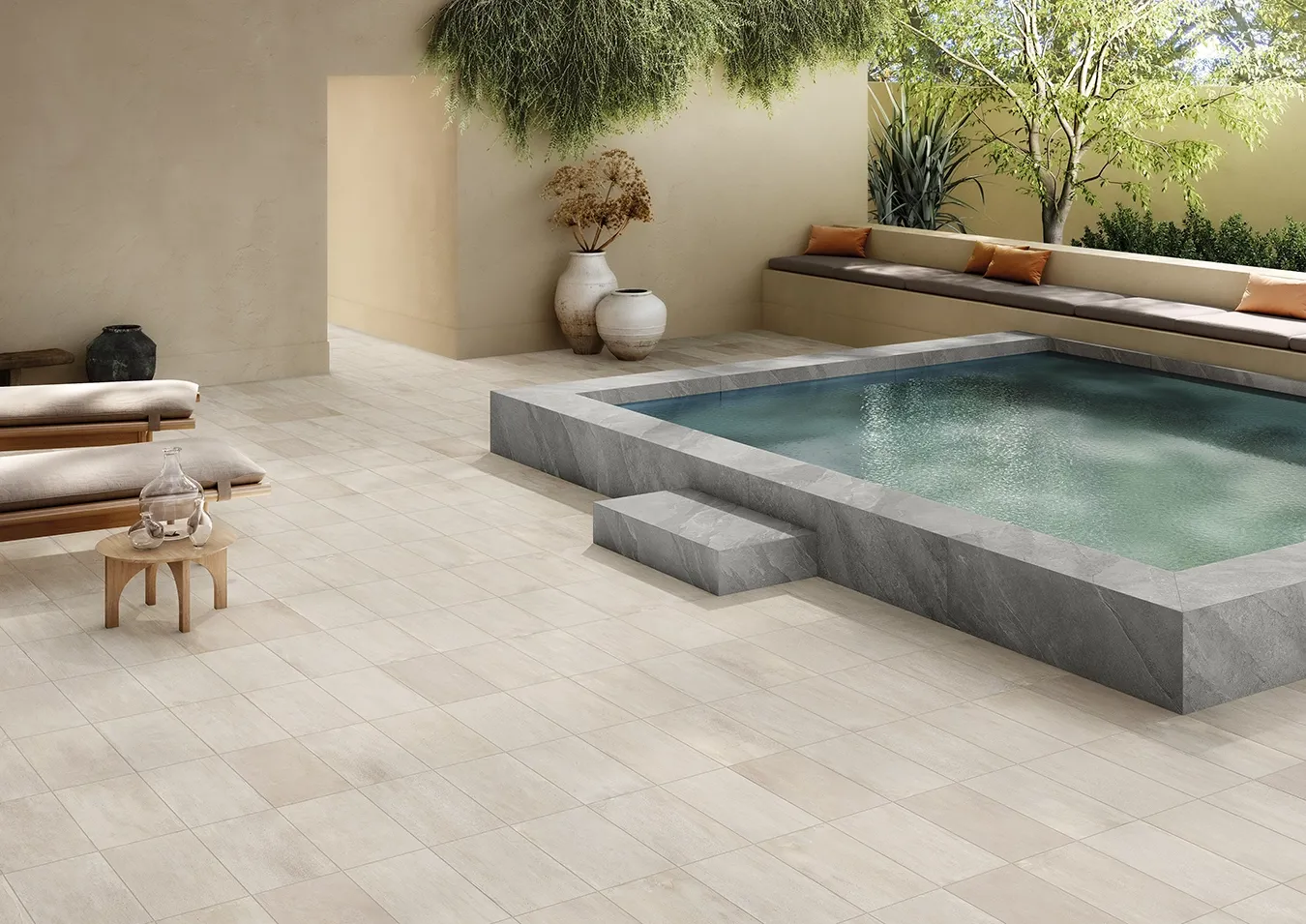 Heat-resistant, ivory stone-effect porcelain pavers around an outdoor pool deck