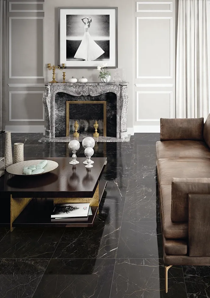 Suelo de gres porcelánico efecto mármol negro con acabado pulido en un salón elegante con chimenea