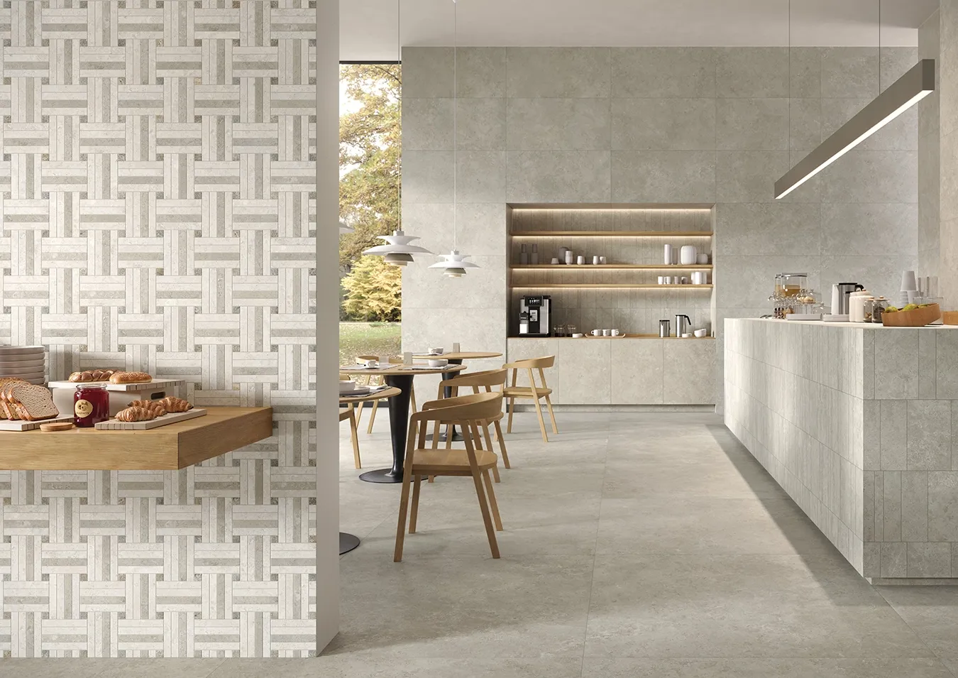 Carrelage en grès cérame effet pierre calcaire gris au sol et aux murs d'un café avec décor tressé et comptoir ton sur ton